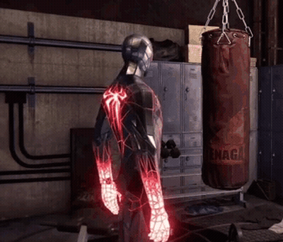 A Man In A Spiderman Suit Is Standing In Front Of A Punching Bag That Says ' Snaga ' On It GIF
