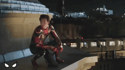 A Man In A Spiderman Suit Sits On A Sidewalk GIF