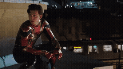 A Man In A Spiderman Suit Squatting Down GIF