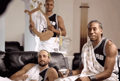 A Man In A Spurs Jersey Sits Next To Two Other Men GIF