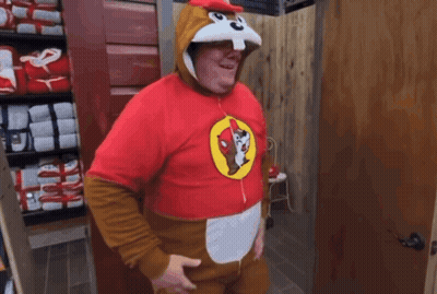 A Man In A Squirrel Costume Is Standing In A Room GIF