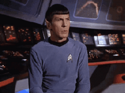 A Man In A Star Trek Uniform Is Sitting In Front Of A Console GIF