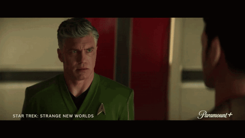 A Man In A Star Trek Uniform Talks To Another Man In A Paramount + Ad GIF