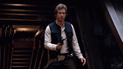 A Man In A Star Wars Outfit Holds A Gun In His Right Hand GIF