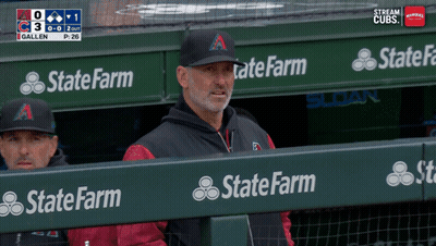 A Man In A State Farm Hat Sits In The Dugout During A Baseball Game GIF
