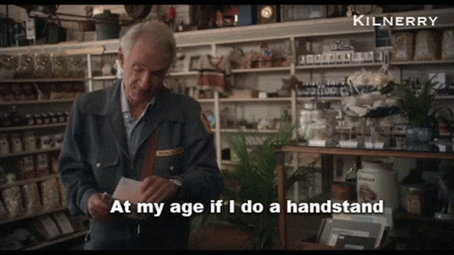 A Man In A Store With The Words At My Age If I Do A Handstand Above Him GIF