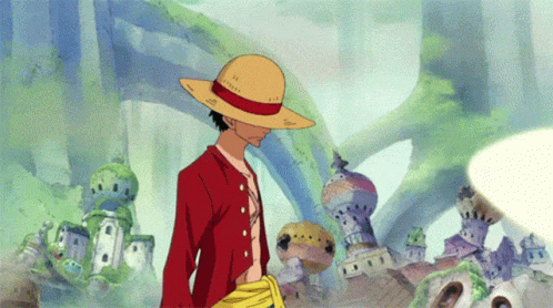 A Man In A Straw Hat Is Standing In Front Of A Castle GIF