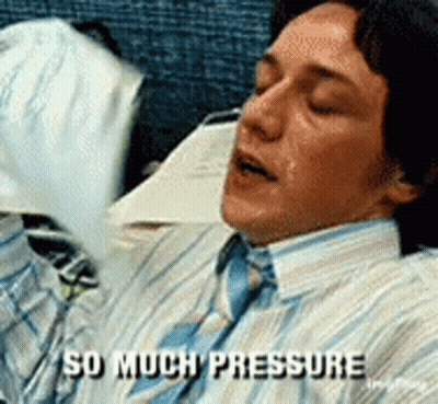 A Man In A Striped Shirt And Tie Is Laying Down And Says " So Much Pressure " GIF