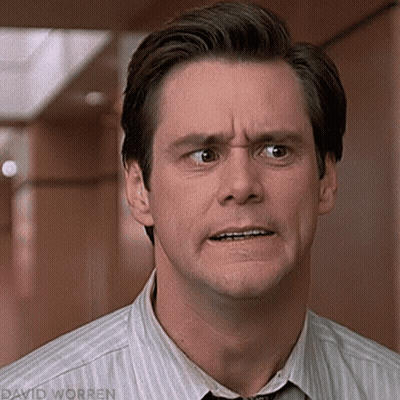 A Man In A Striped Shirt And Tie Making A Funny Face GIF