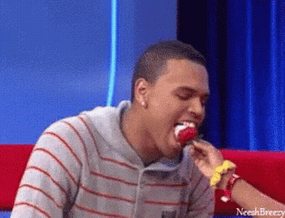 A Man In A Striped Shirt Is Eating A Lollipop With The Name Neeshbreezy On The Bottom GIF