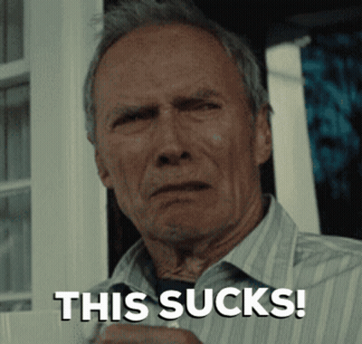 A Man In A Striped Shirt Is Holding A Cup And Says " This Sucks " GIF