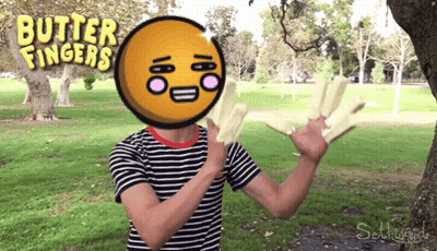 A Man In A Striped Shirt Is Holding Butter Fingers GIF