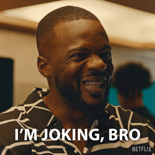 A Man In A Striped Shirt Is Laughing And Says I 'M Joking Bro GIF