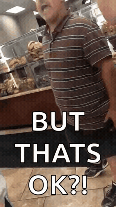 A Man In A Striped Shirt Is Standing In A Bakery And Says But That 'S Ok . GIF