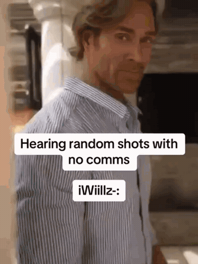 A Man In A Striped Shirt Is Standing In Front Of A Sign That Says Hearing Random Shots With No Comms . GIF