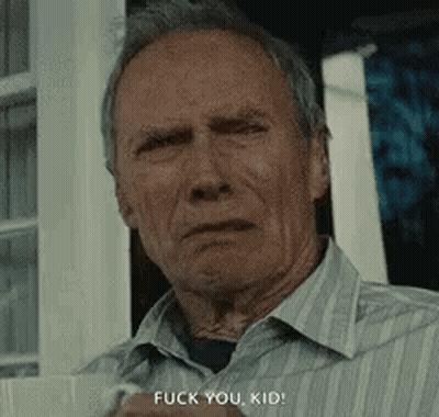A Man In A Striped Shirt Is Standing In Front Of A Window And Says `` Fuck You Kid '' . GIF
