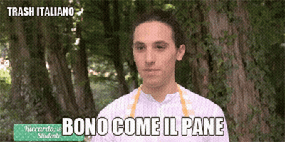 A Man In A Striped Shirt Is Standing In Front Of Trees And Says Bono Come Il Pane GIF