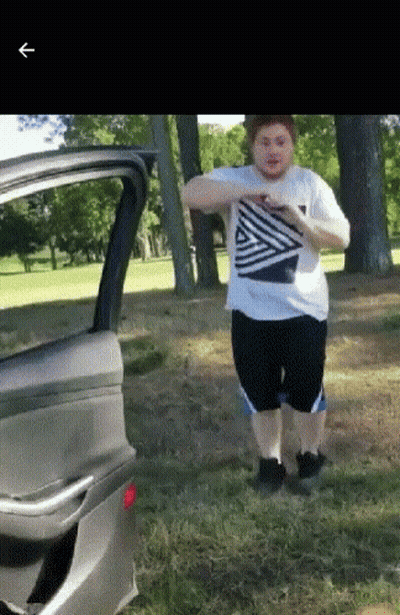 A Man In A Striped Shirt Is Standing Next To A Car Door GIF