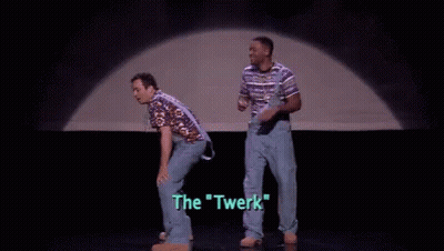 A Man In A Striped Shirt Is Standing On A Stage With The Words `` The Twerk '' Written On The Screen . GIF