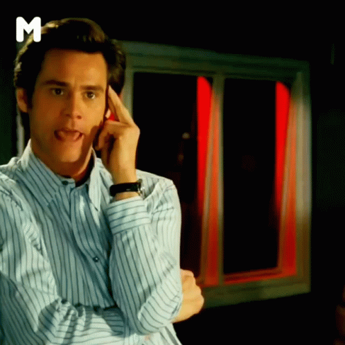 A Man In A Striped Shirt Is Sticking His Tongue Out In Front Of A Window That Has The Letter M On It GIF