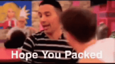 A Man In A Striped Shirt Is Talking To Another Man While Sitting At A Table . GIF