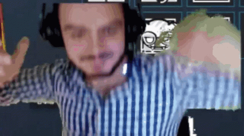 A Man In A Striped Shirt Is Wearing Headphones And Giving A Peace Sign GIF
