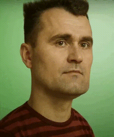 A Man In A Striped Shirt Looks At The Camera With A Green Background GIF