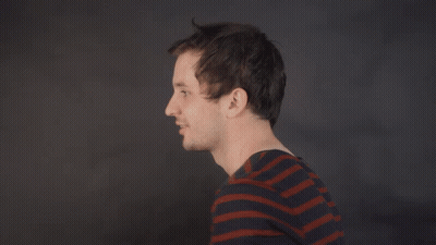 a man in a striped shirt says " deal with it " in white letters