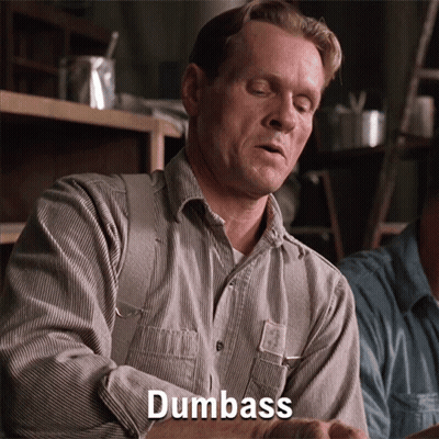 A Man In A Striped Shirt Says Dumbass In Front Of Him GIF