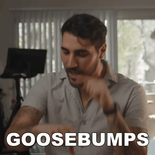 A Man In A Striped Shirt Says " Goosebumps " GIF