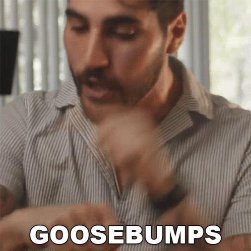 A Man In A Striped Shirt Says Goosebumps In Front Of His Face GIF