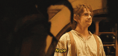 A Man In A Striped Shirt Says Nope In A Dark Room GIF
