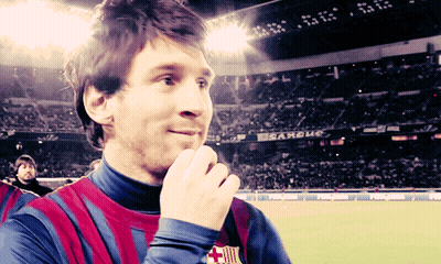 A Man In A Striped Shirt Stands In Front Of A Sign That Says ' Estadio ' On It GIF