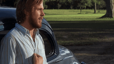 A Man In A Striped Shirt Stands Next To A Car GIF
