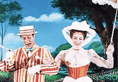 A Man In A Striped Suit And A Woman In A White Dress Are Standing Next To Each Other GIF