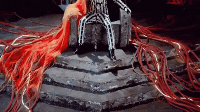 A Man In A Striped Suit Is Sitting On A Throne GIF