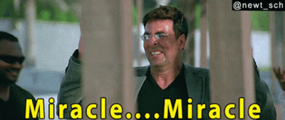 A Man In A Suit And Black Shirt Is Smiling With The Words " Miracle ... Miracle " Behind Him GIF