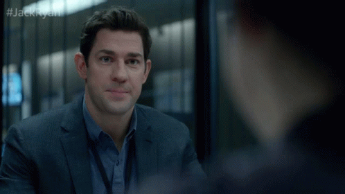 A Man In A Suit And Blue Shirt Talks To Another Man With The Hashtag #Jackryan GIF