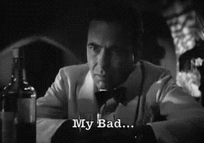 A Man In A Suit And Bow Tie Is Sitting At A Table With A Glass Of Wine And A Bottle Of Alcohol . GIF