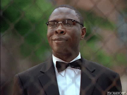 A Man In A Suit And Bow Tie Is Smiling And Looking Up . GIF