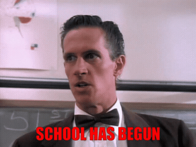 A Man In A Suit And Bow Tie Says School Has Begun In Red GIF