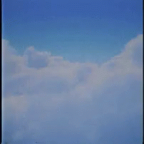 A Man In A Suit And Glasses Is Floating In The Clouds . GIF