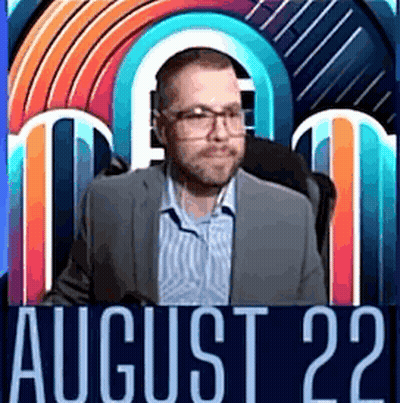 A Man In A Suit And Glasses Is Standing In Front Of A Colorful Background With The Date August 22 . GIF