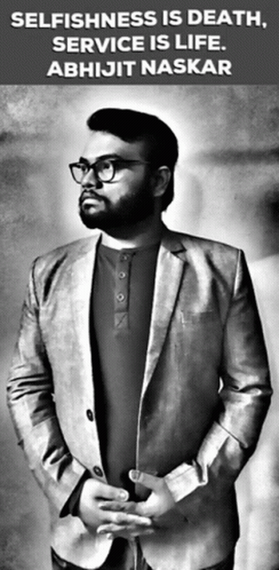 A Man In A Suit And Glasses Is Standing In Front Of A Sign That Says Selfishness Is Death Service Is Life GIF