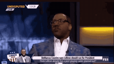 A Man In A Suit And Glasses Is Talking On A Tv Show Called Undisputed GIF