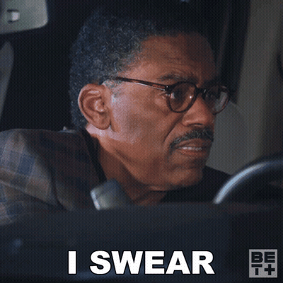 A Man In A Suit And Glasses Says I Swear While Driving A Car GIF