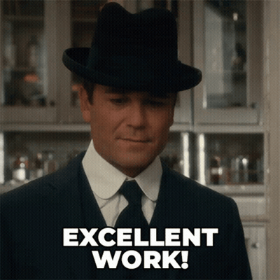 A Man In A Suit And Hat Is Giving An Excellent Work Sign GIF