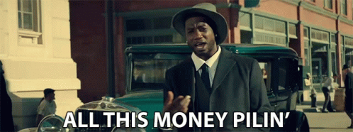A Man In A Suit And Hat Is Standing In Front Of A Car And Says All This Money Pilin ' GIF