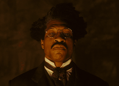 A Man In A Suit And Hat Stands In Front Of A Crowd Of People Watching A Lightning Strike GIF