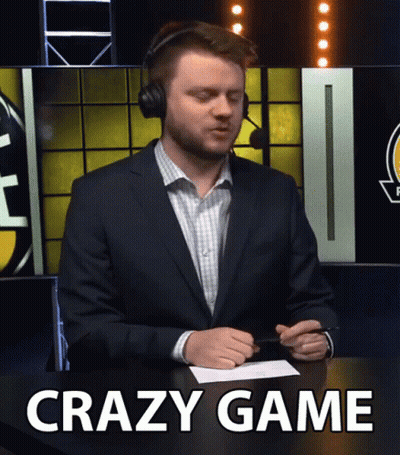 A Man In A Suit And Headphones Sitting At A Table With The Words Crazy Game Written On The Bottom GIF